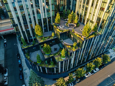 A modern building with a green courtyard in the middle.