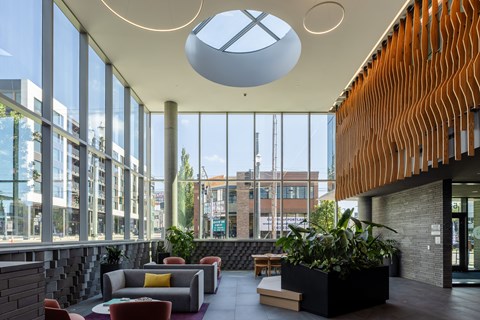 A modern interior with a skylight and a wooden wall.