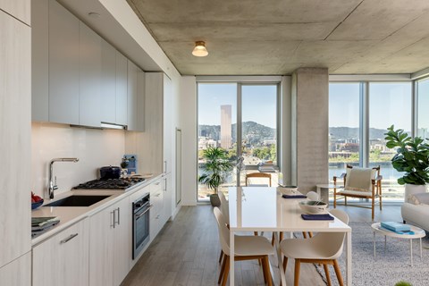 A modern kitchen with a dining table and chairs.