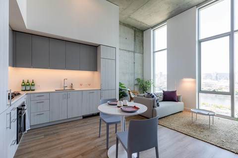 A modern kitchen with a dining table and chairs.