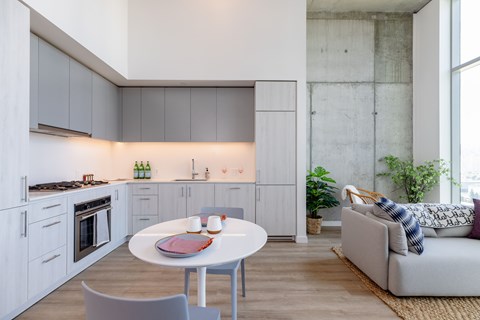 A modern kitchen with a dining table and chairs.