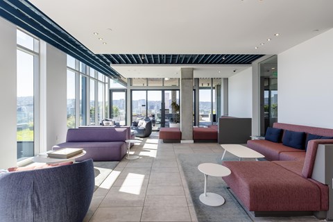 A modern waiting area with purple and red couches.