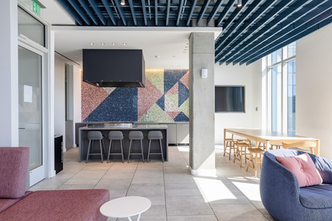 A modern living room with a bar area and a television.