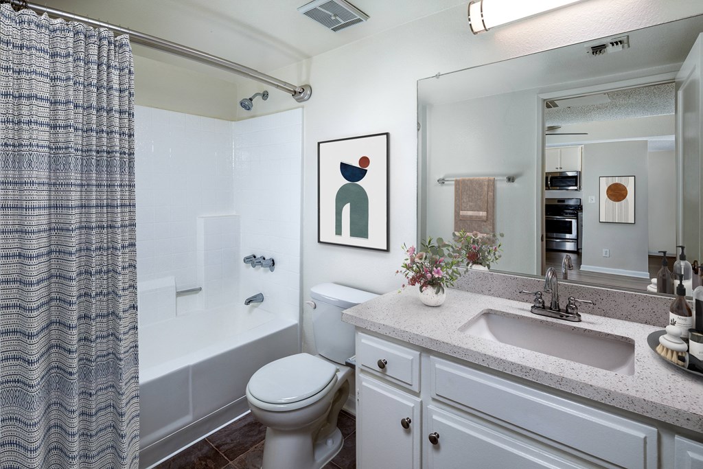 a bathroom with sink toilet and shower