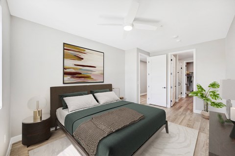a bedroom with a large bed and a large painting on the wall