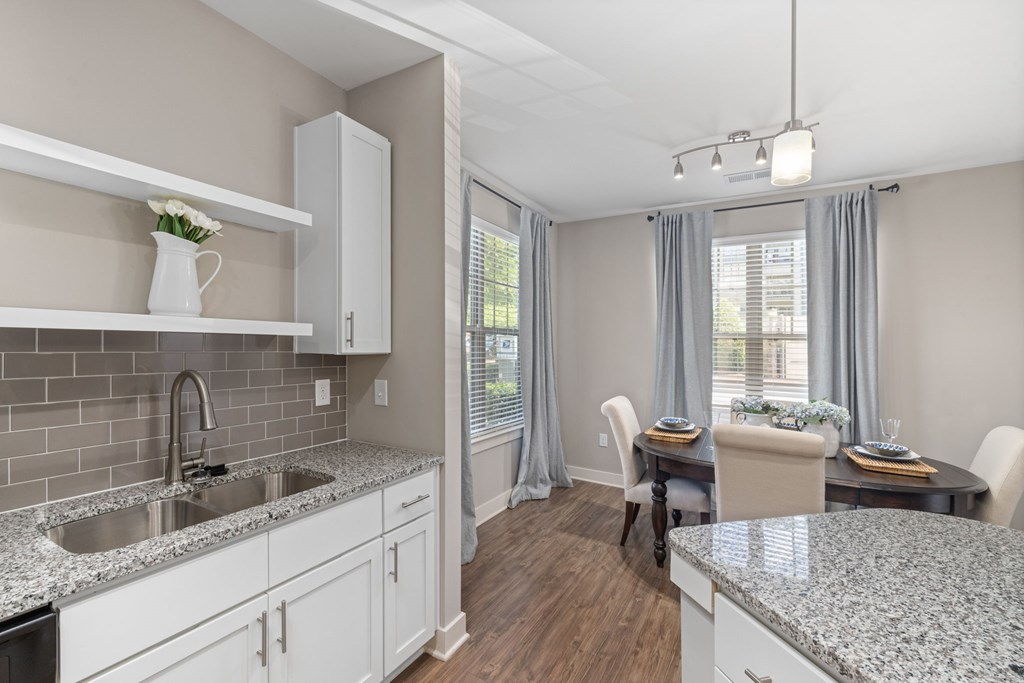 A kitchen with a dining table set for two.
