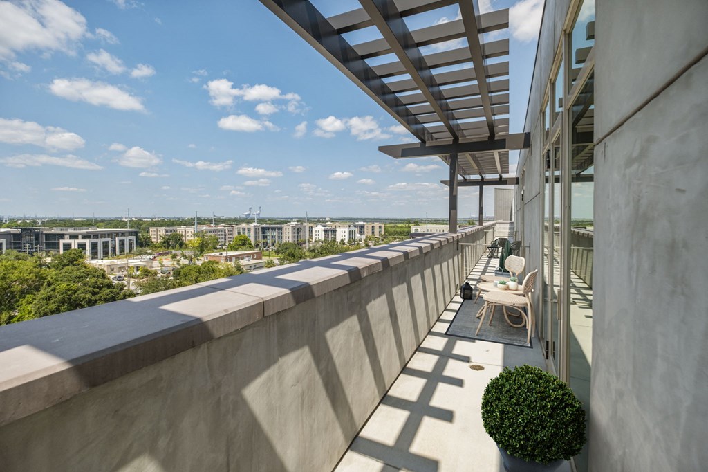 a balcony with chairs and a table on it