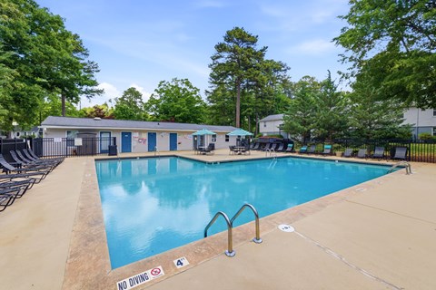 A pool with a no diving sign in the foreground.