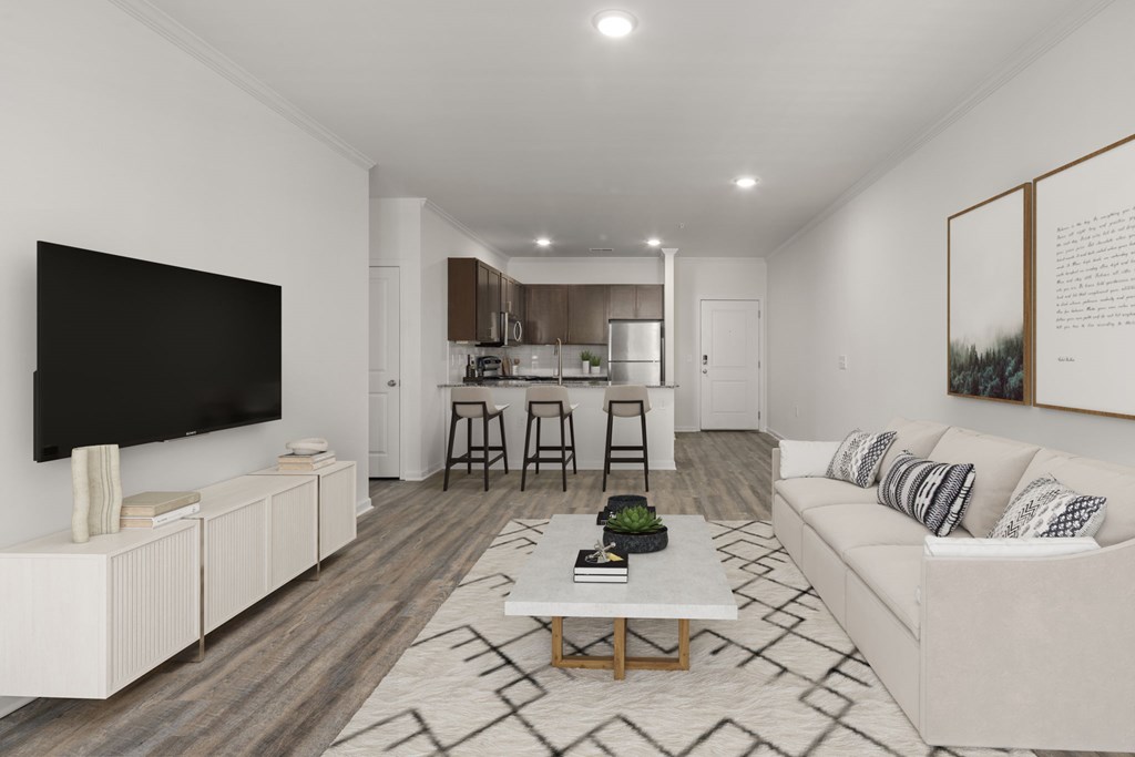 A modern living room with a white couch and a television.