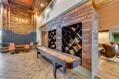 A room with a wooden floor and a bookshelf with books.