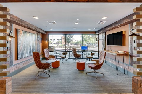 A modern living room with a television and comfortable seating.