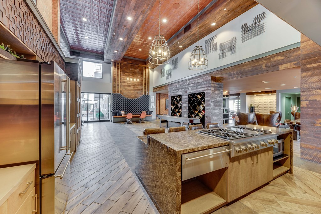 A modern kitchen with a wooden island and stainless steel appliances.