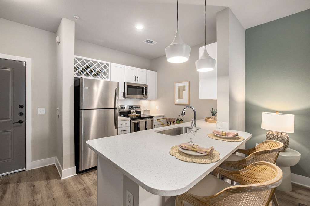 a kitchen with stainless steel appliances and a white counter top