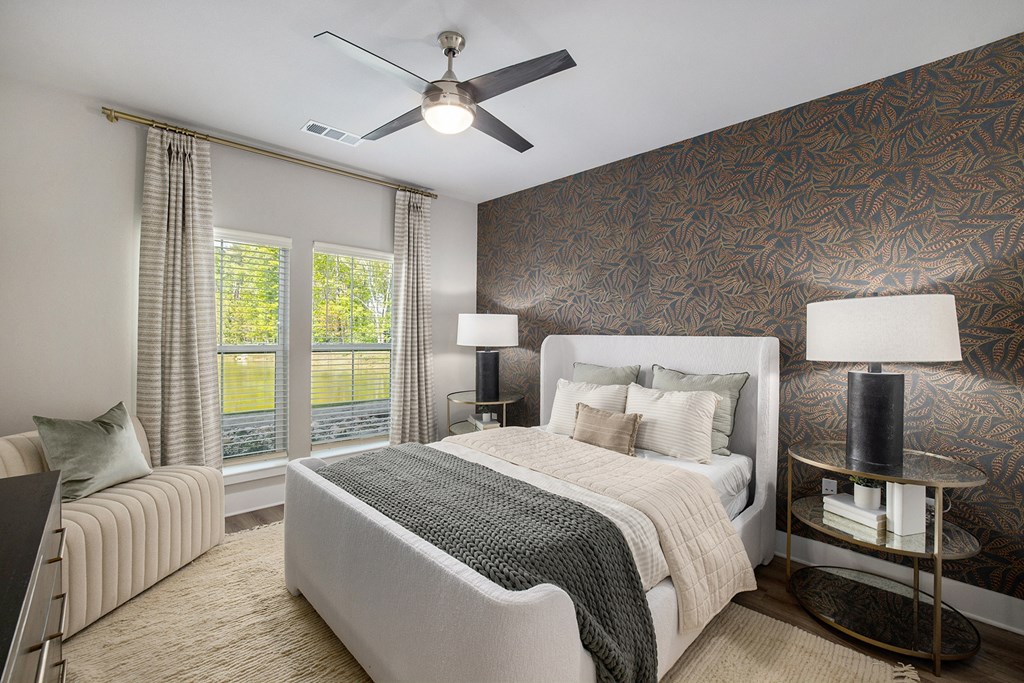 a bedroom with a large bed and a ceiling fan