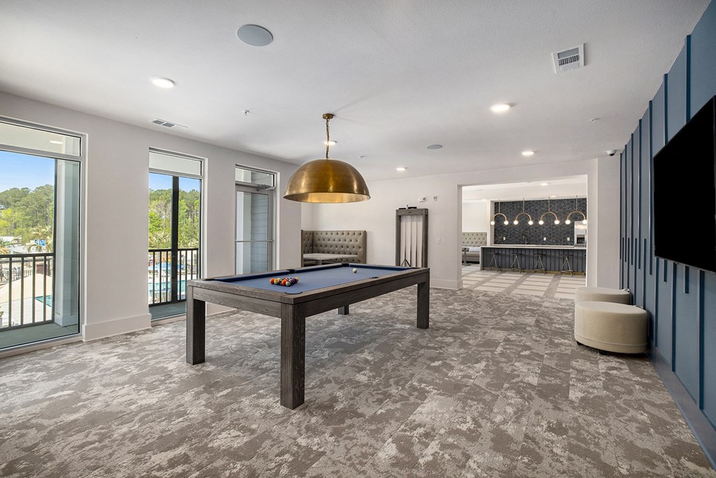 a game room with a pool table and a bar