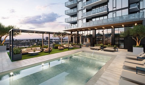 A modern building with a pool in front.