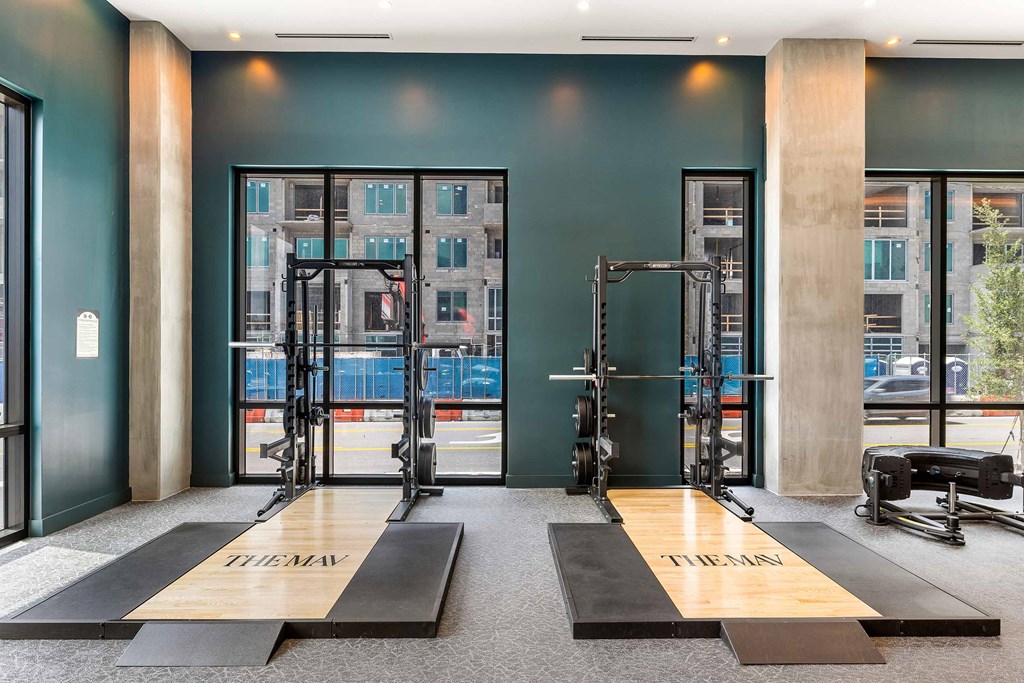 a gym with weights machines and a window