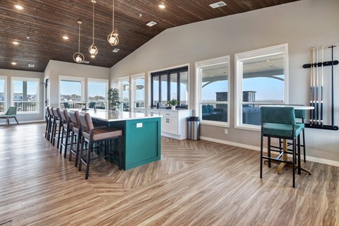a kitchen and dining room with windows and a table with chairs