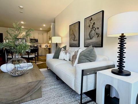 A living room with a white couch and a coffee table.