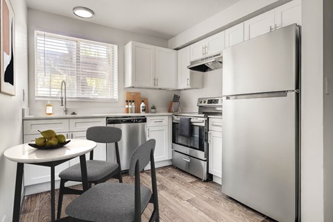 A modern kitchen with a table and chairs.