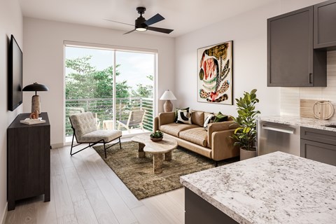 A living room with a couch, chair, and a painting on the wall.