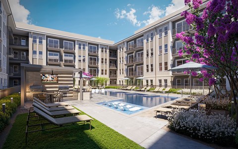 A pool surrounded by lounge chairs and a building with a mural on the side.