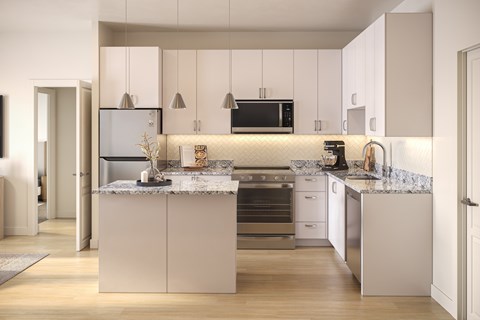 A modern kitchen with a central island and stainless steel appliances.