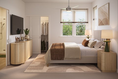 A bedroom with a large bed and a television on the wall.