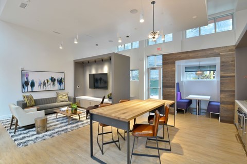 A modern living room with a wooden table and chairs.