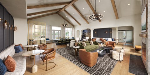 A spacious living room with a high ceiling and wooden beams.