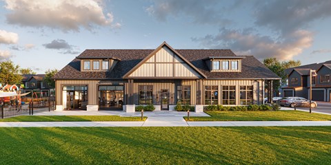 A modern house with a large front yard and a driveway.