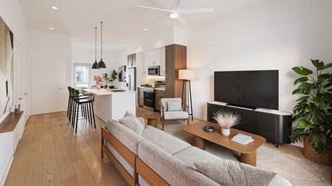 A modern living room with a grey sofa and a black television.