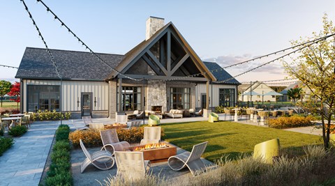 A modern house with a large front yard and patio furniture.