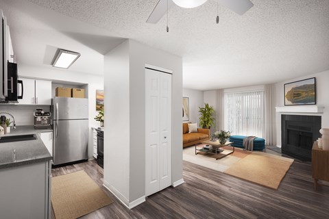 A modern kitchen with a refrigerator, microwave, and oven.