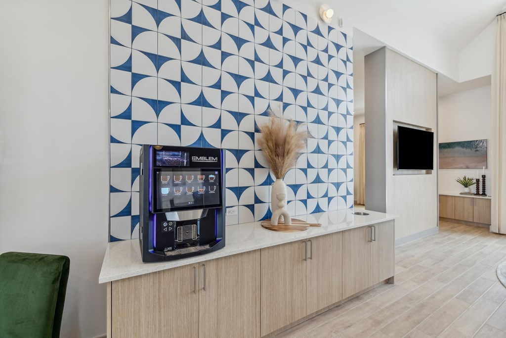 a lobby with a coffee machine and a blue geometric wall