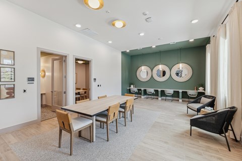 a dining room with a wooden table and chairs