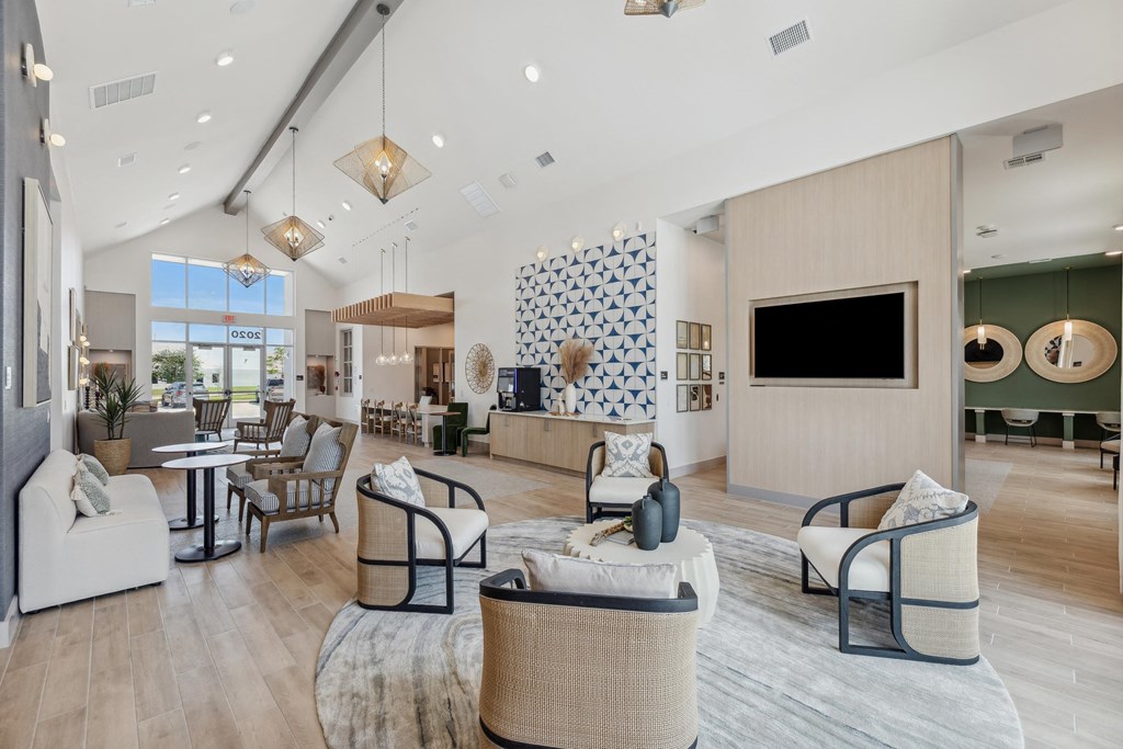 a living room with couches and chairs and a tv