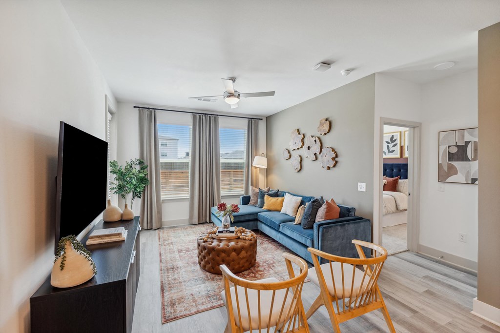 a living room with a blue couch and a tv