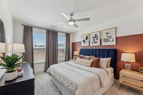 a bedroom with a large bed and a ceiling fan