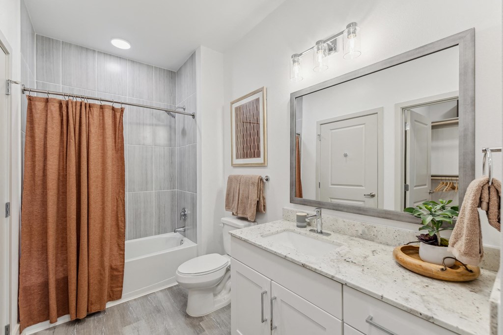 bathroom with shower and granite countertops