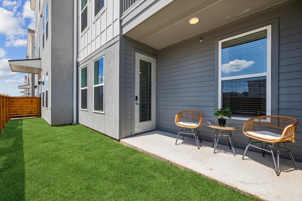 fenced yard attached to apartment home with patio