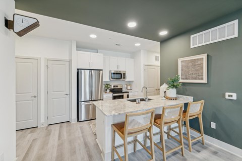 a kitchen with stainless steel appliances and a marble counter top