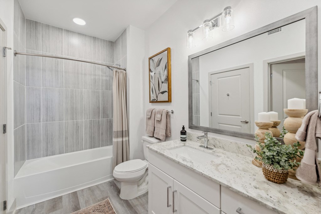 a bathroom with a shower and a sink and a toilet