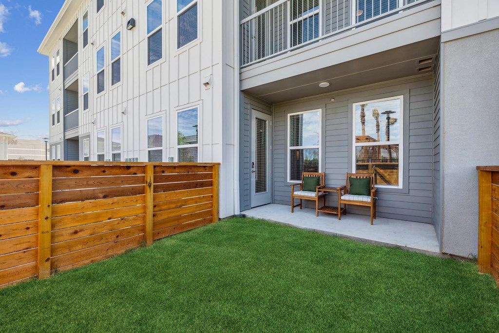 fenced yard attached to apartment home with patio