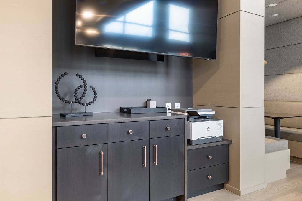 A black cabinet with a flat screen TV mounted above it.