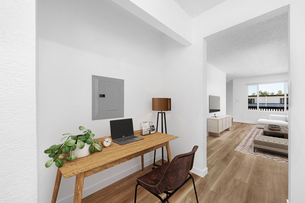 A room with a desk and a laptop on it.