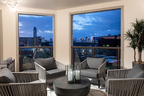 a living room with chairs and a view of the city at night