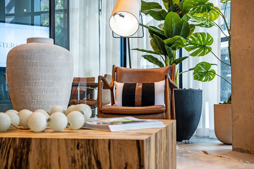 A table with a vase, a lamp, and some decorative balls on it.
