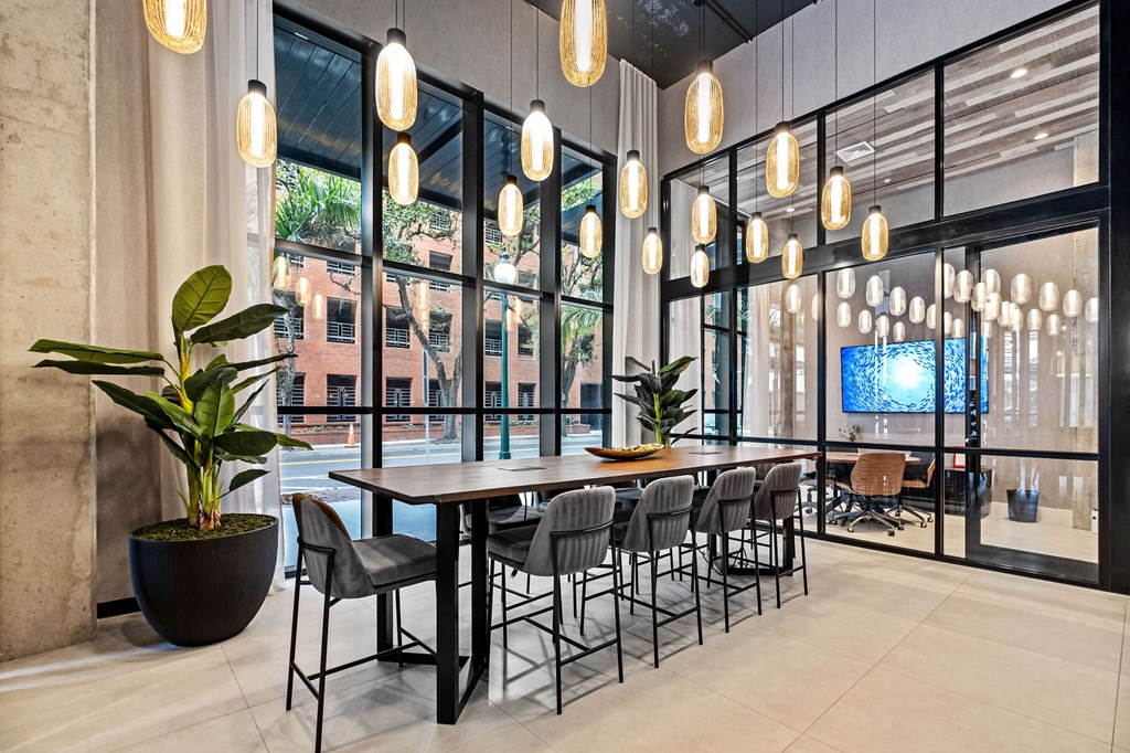 A modern dining room with a large table and chairs.