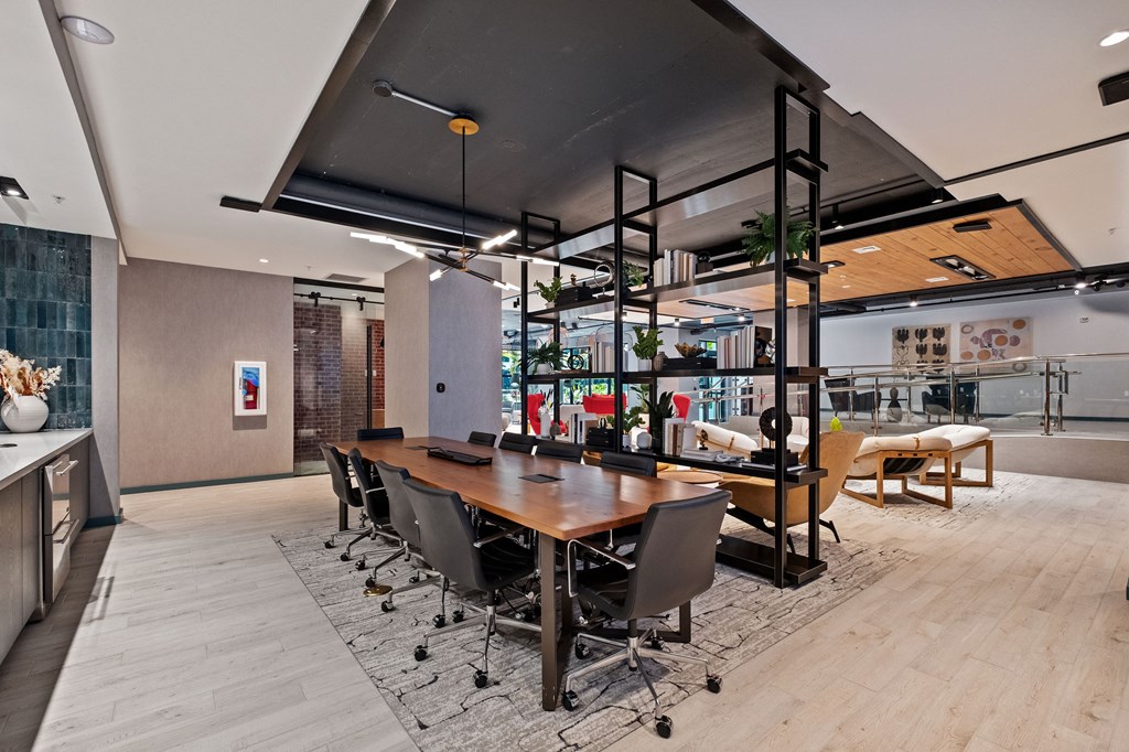 A conference room with a long table and chairs.